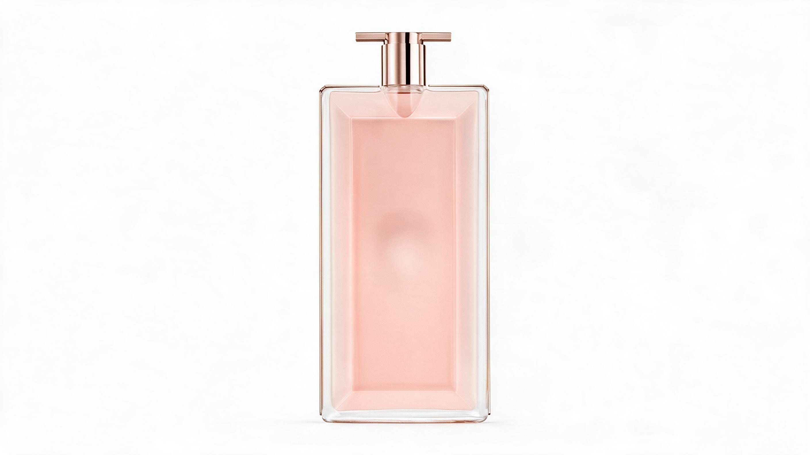 Studio product photography of a round spherical glass perfume bottle with pink and gold cap, elegant ribbon detail aroun