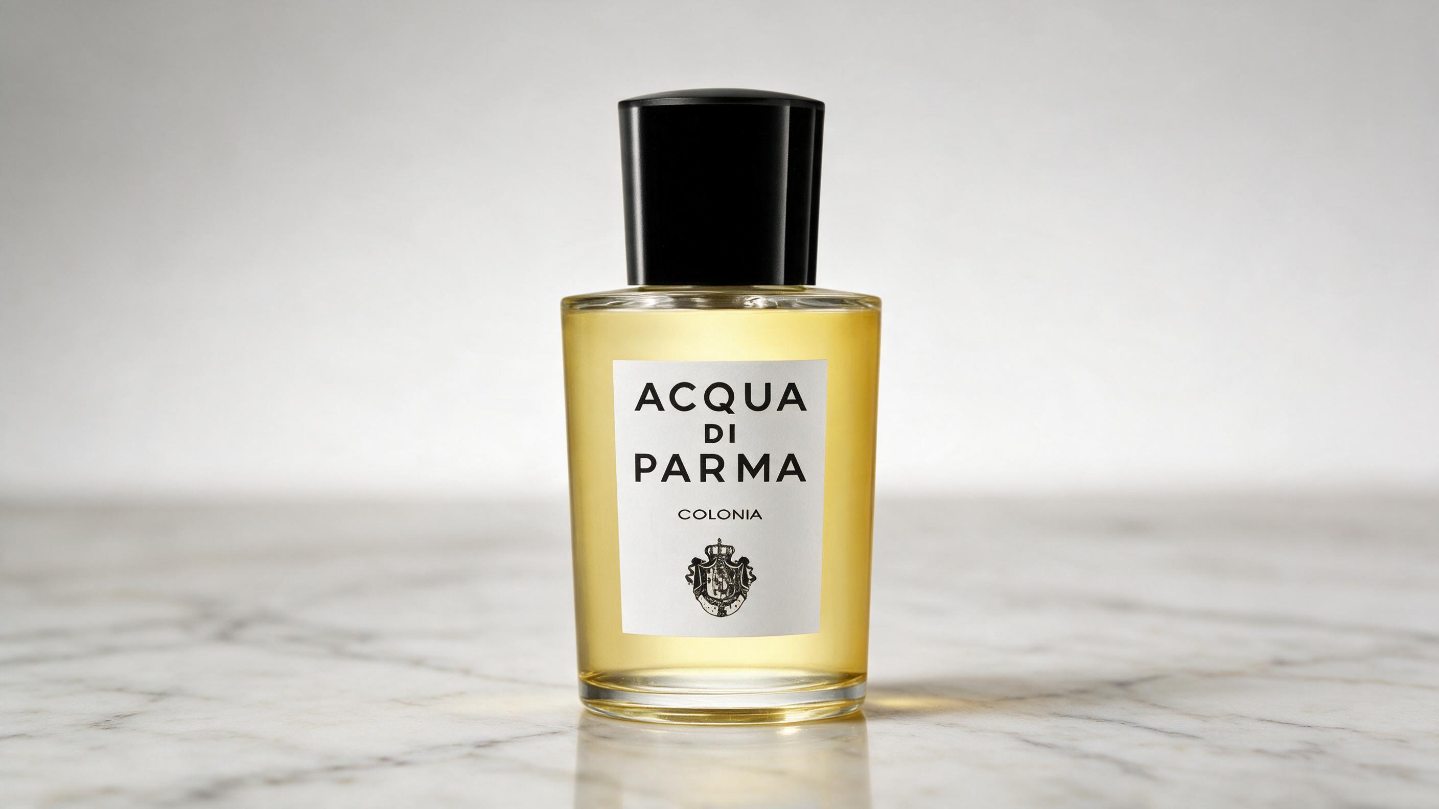 elegant clear glass perfume bottle with pale yellow liquid, minimalist rounded cap, classic Italian luxury cologne bottl