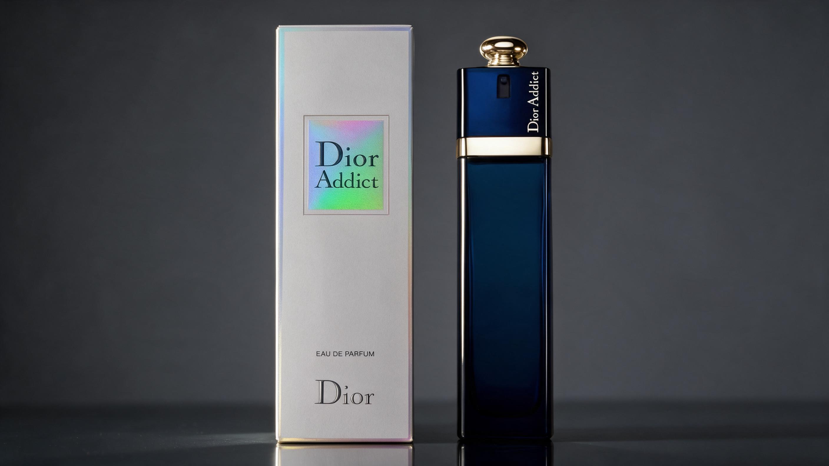 elegant perfume bottle of a translucent champagne-colored liquid, geometric faceted glass design with a round silver-gol