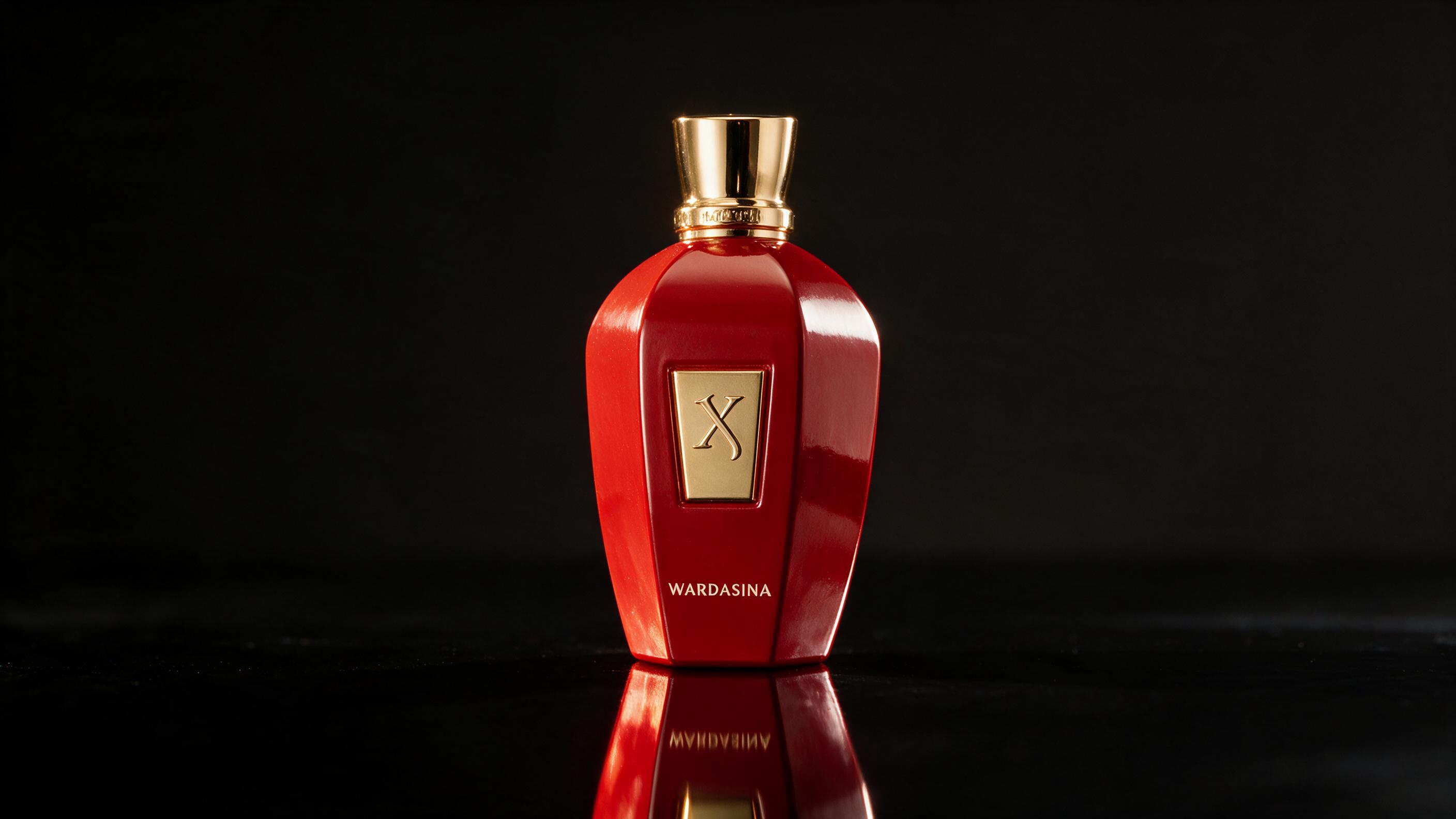 Elegant tall amber perfume bottle with a dark cap standing on a reflective black surface, dramatic side lighting, deep r