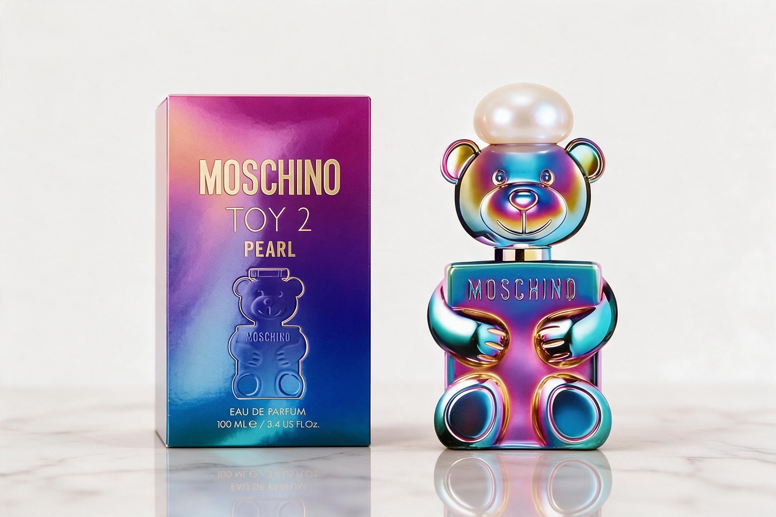 elegant glass perfume bottle with a soft pearl-white rounded cap, standing on a reflective marble surface, soft diffused
