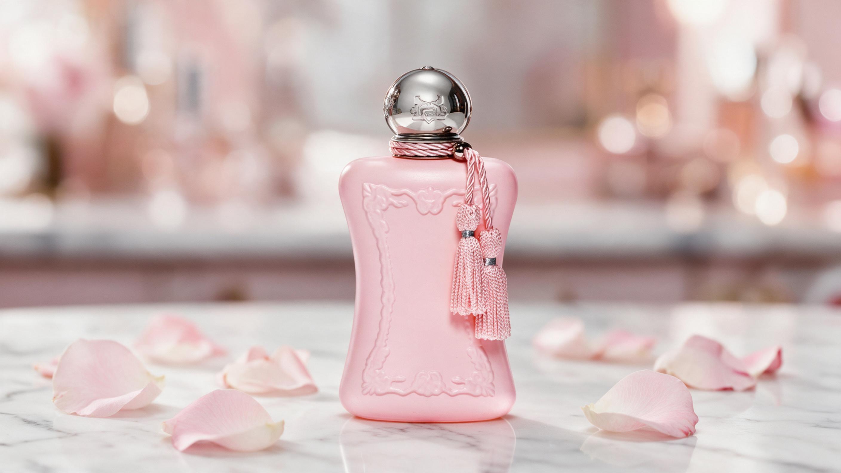 elegant perfume bottle with rose gold cap standing on a white marble surface, soft rose petals scattered around the base