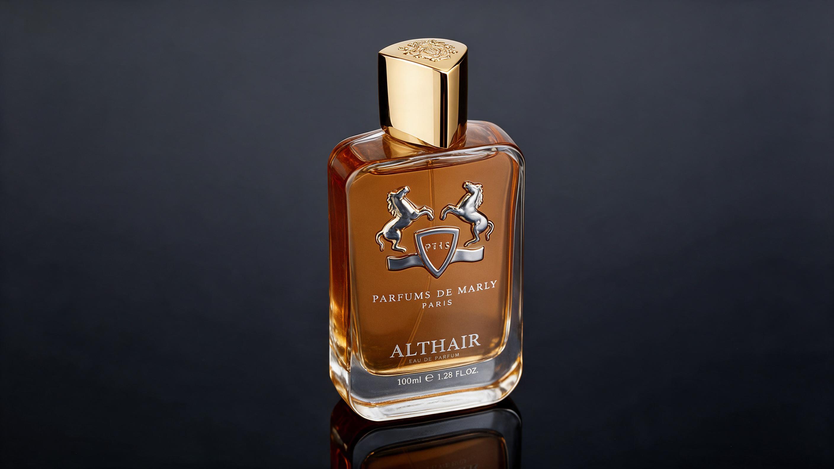 professional product photography of an elegant men's eau de parfum bottle with gold cap and warm amber-toned liquid