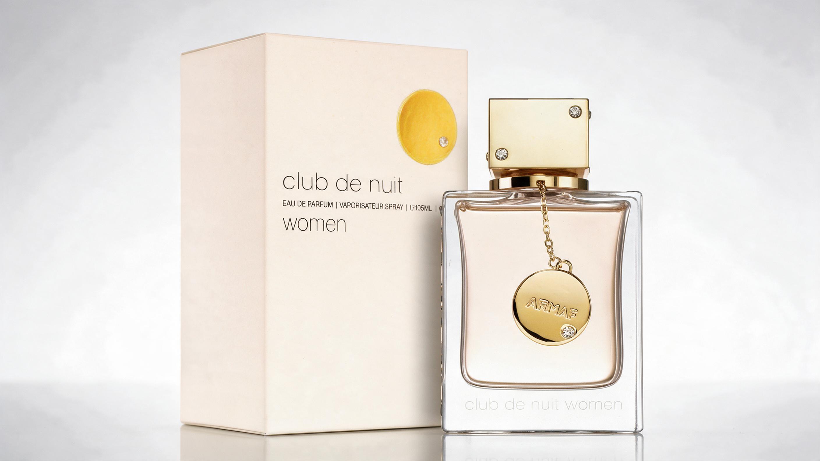 professional studio product photograph of an Armaf Club de Nuit perfume bottle, elegant glass bottle with gold cap, cent