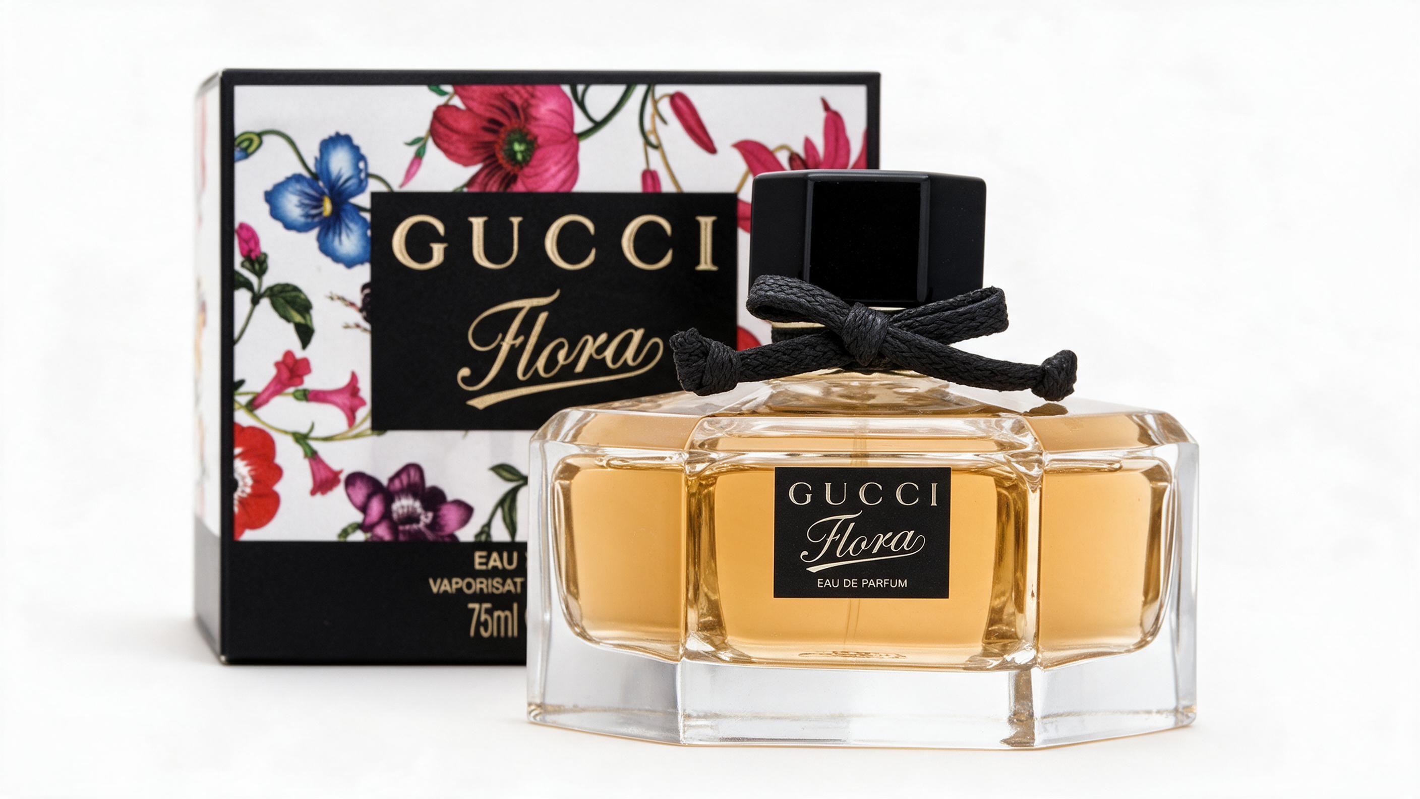 elegant studio product photograph of a Gucci Flora perfume bottle with pink floral-patterned cap, clean white background